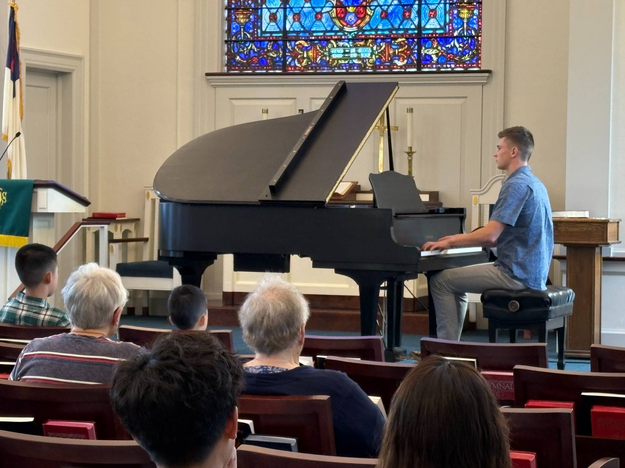 One of the pianists performing at the front of the church